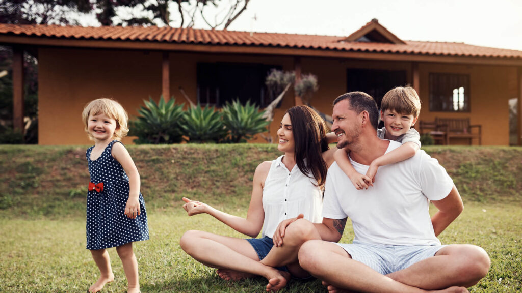 Family sitting outside home