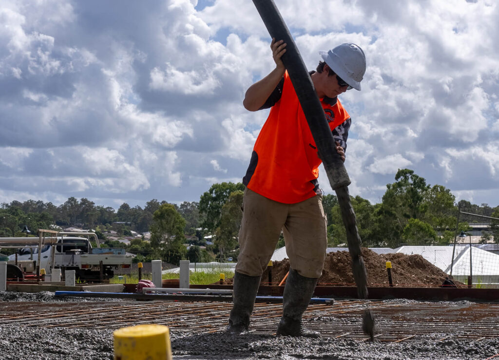 Concrete being poured over Biax pods and steel