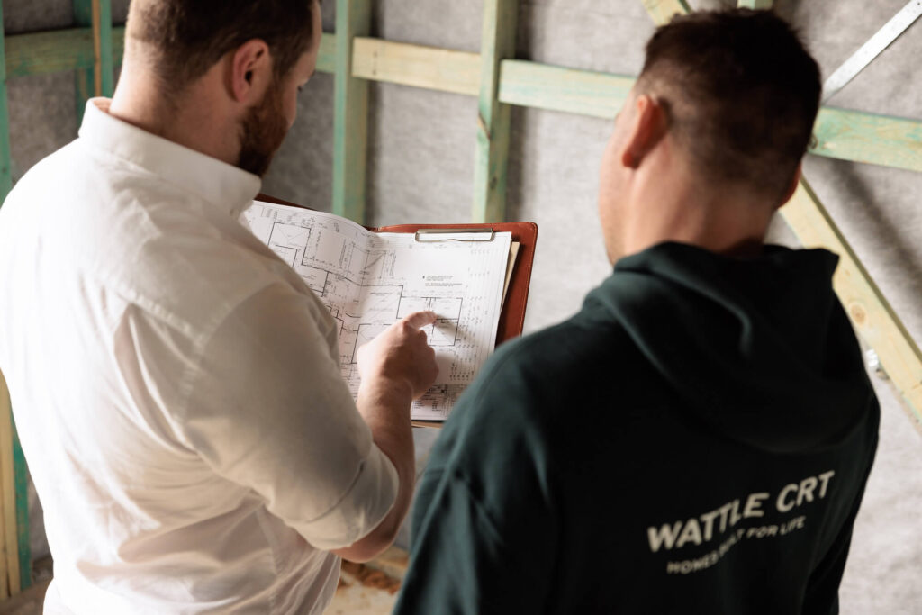 Builder and carpenter discussing home plans