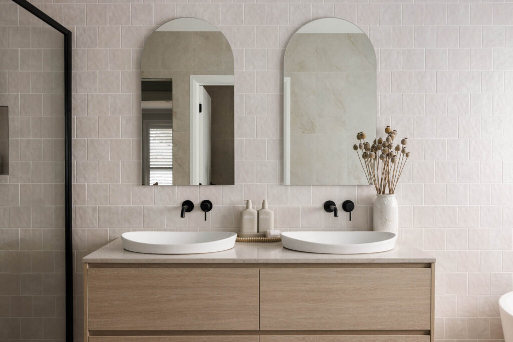 Bathroom with arched mirrors and soft sculpted shapes